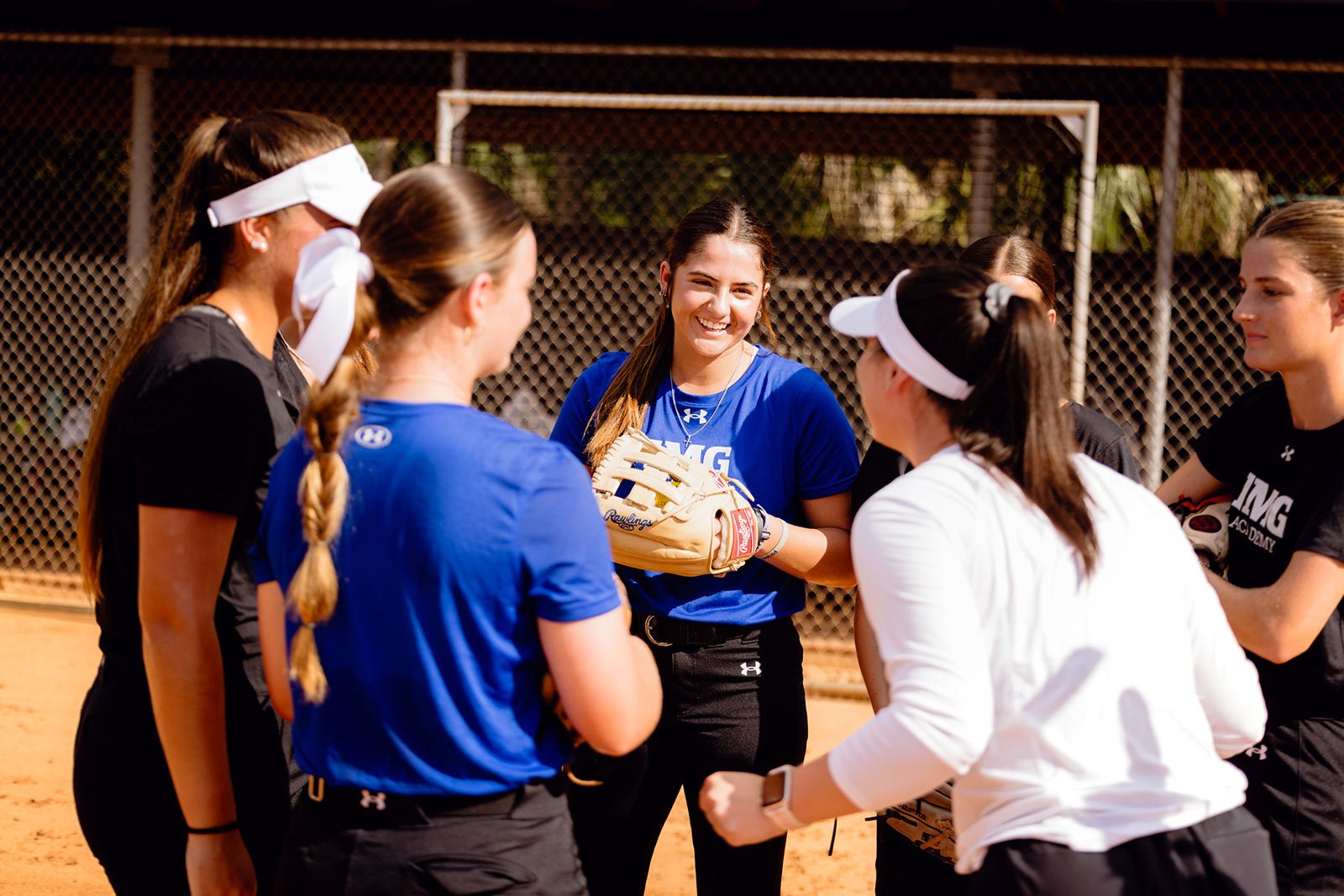 Softball students standing in a huddle