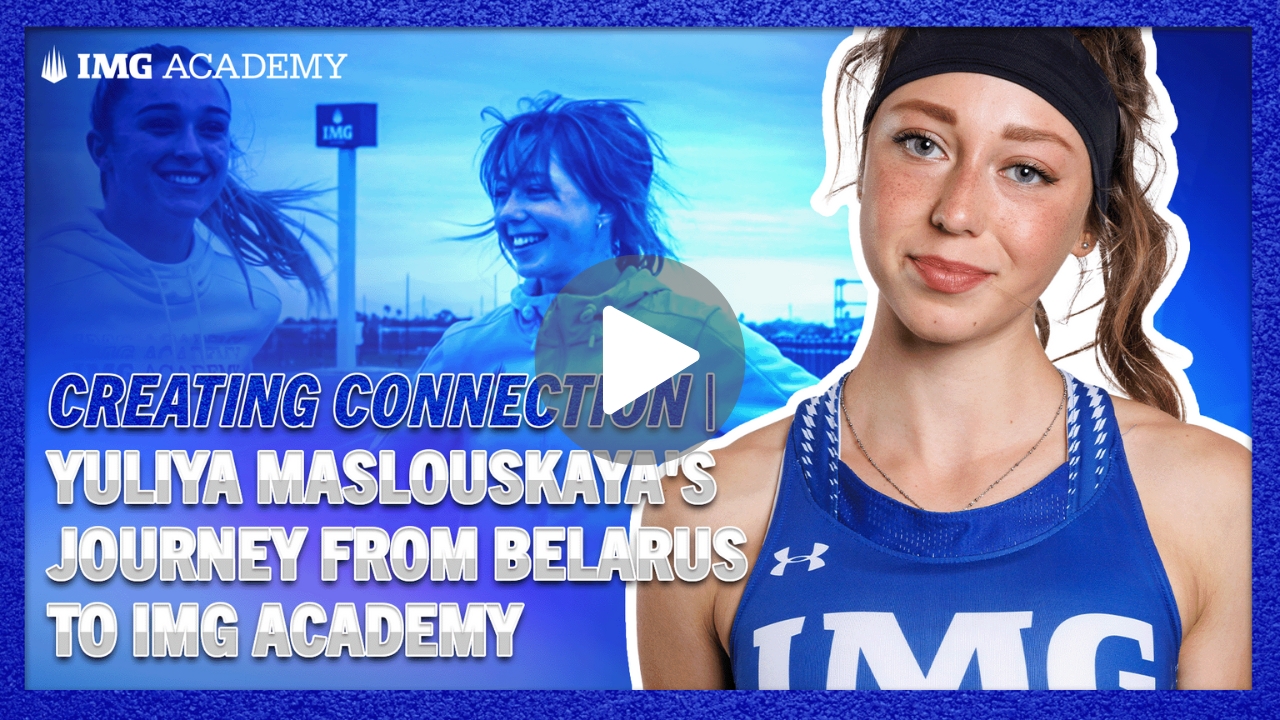 A basketball player from the img academy is holding a wilson basketball